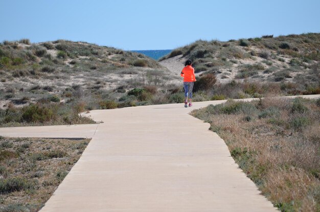 Full length of woman walking on landscape