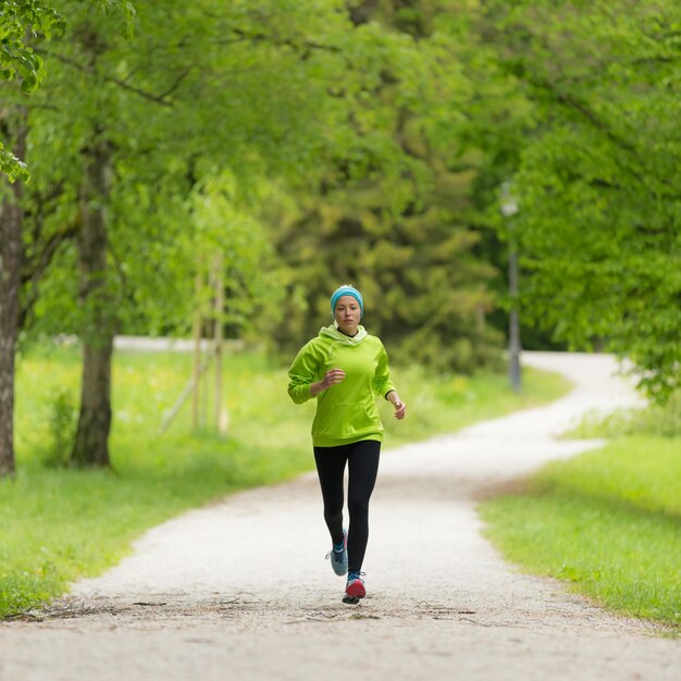 Full length of woman with running on forest