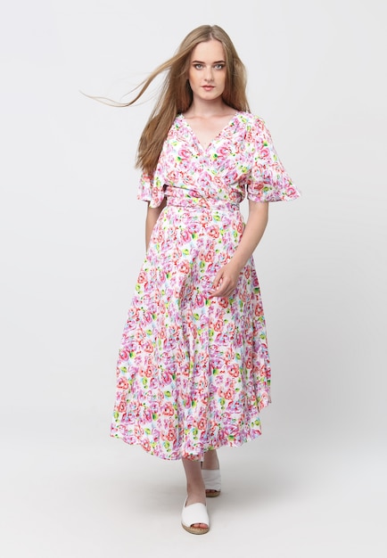 Full length of a young elegant girl in a light summer dress, on a light space. advertising concept for clothing stores. Content for social networks and banners.