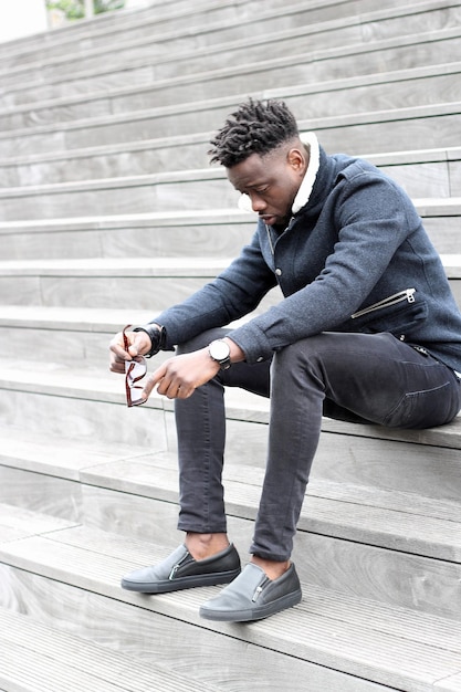 Photo full length of young man sitting on staircase in city