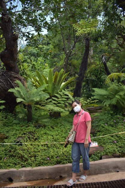 Full length of young man standing against trees