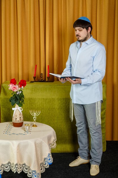 Full length of young man standing against white wall