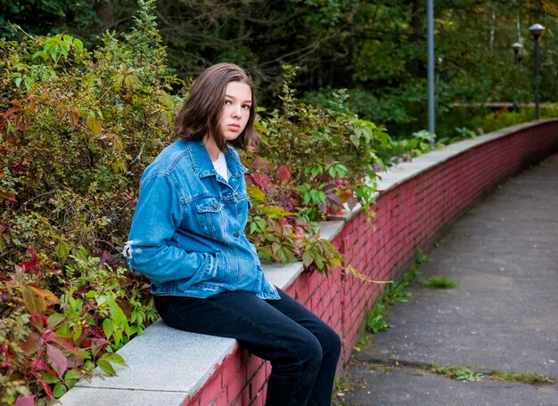 Full length of young woman sitting outdoors