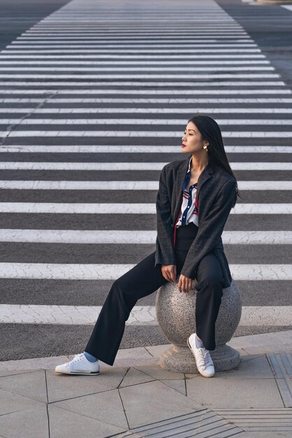 Full length of young woman sitting on steps