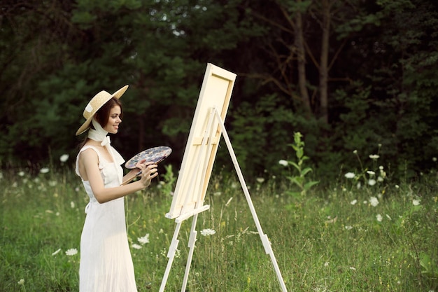 Full length of young woman standing against trees