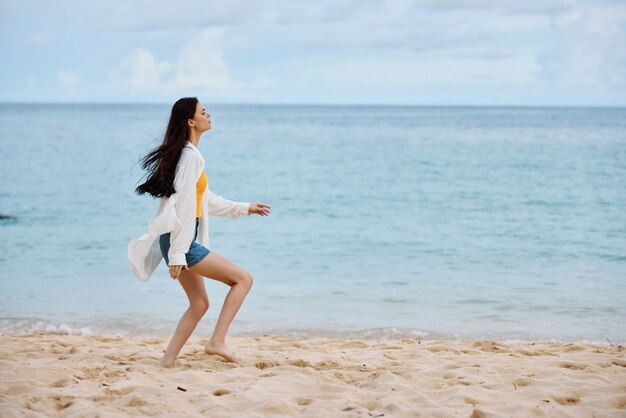 Full length of young woman standing at beach