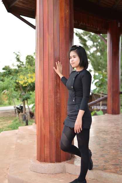 Full length of young woman standing in gazebo