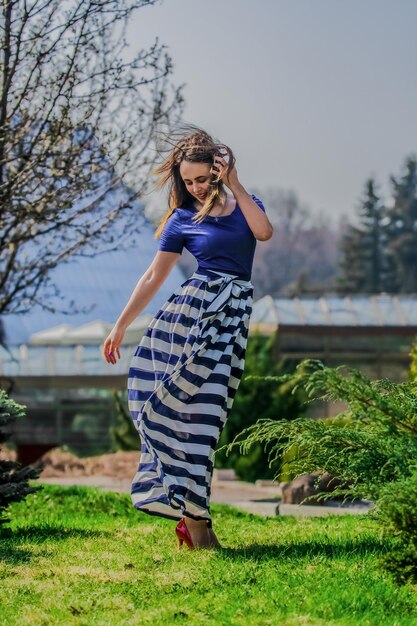 Full length of young woman standing at park