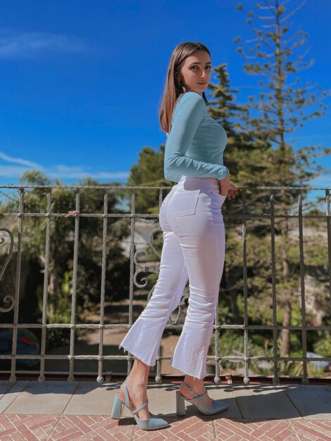 Full length of young woman standing in swimming pool