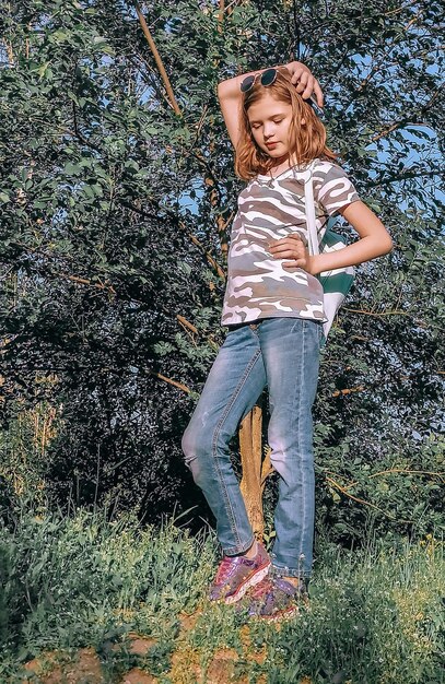 Photo full length of young woman standing on tree