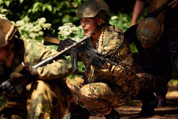 Full military experience One day commando running through the water with automatic rifle replica