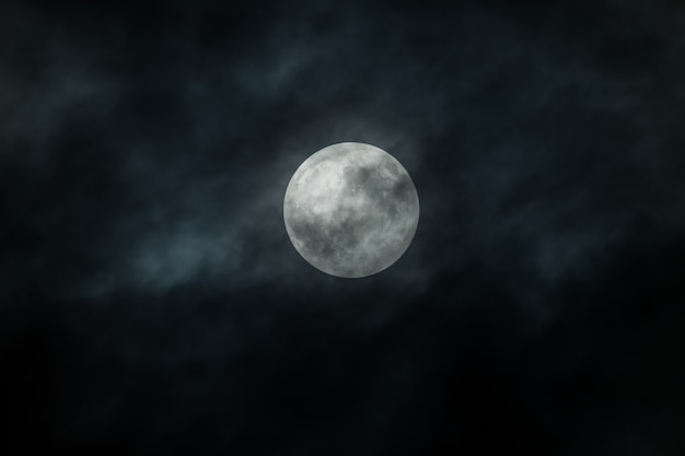 Full Moon and clouds on the night sky