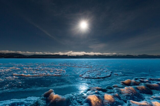 Full moon over frozen lake laberge yukon canada