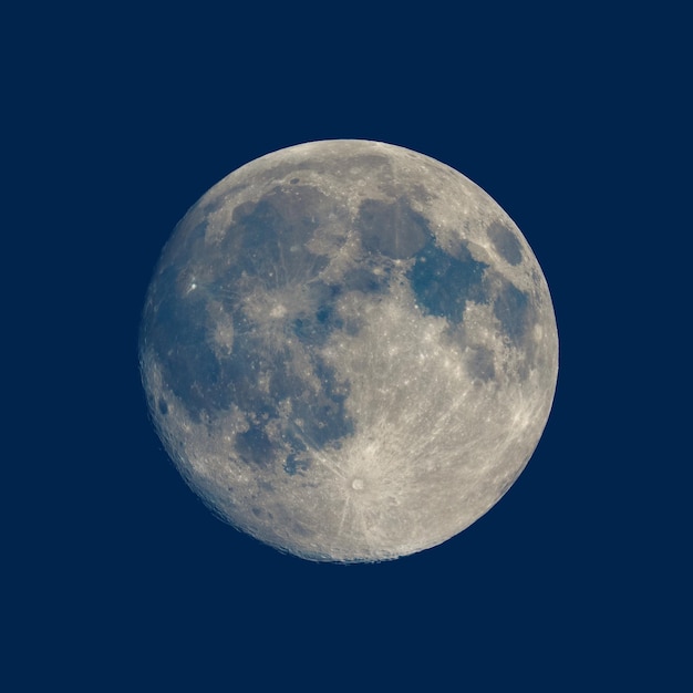 Photo full moon seen with telescope over blue