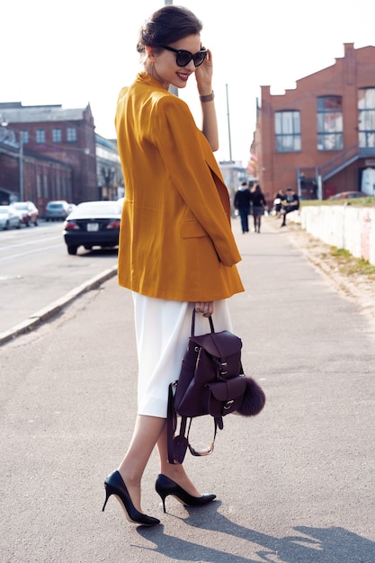 Full photo of stylish happy young business woman walking on the street