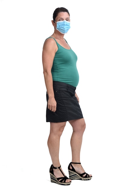 Full portrait of pregnant woman with mask on white background