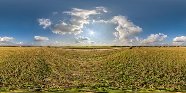 Full seamless 360 hdri panorama view among farming field with sun and clouds in overcast sky in equirectangular spherical projection ready for use as sky replacement in drone panoramas or VR content