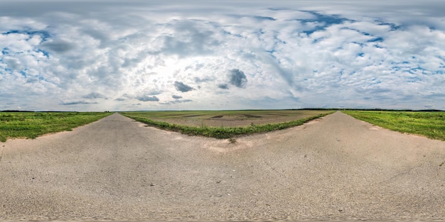 Full seamless spherical panorama 360 by 180 degrees angle view on gravel road among fields with awesome clouds in equirectangular projection skybox VR virtual reality content