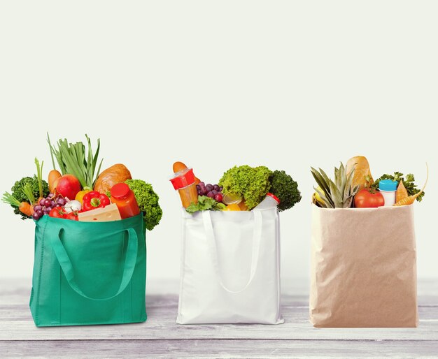 Full shopping  bags on wood tablet and window background