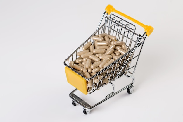 Full shopping cart of medicine, pharmaceutical capsules on white background. Medicine concept.