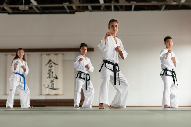 Full shot asian people practicing taekwondo