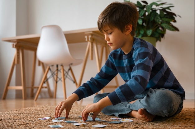 Photo full shot boy playing memory game