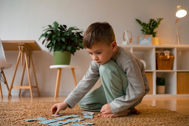 Photo full shot boy playing memory game