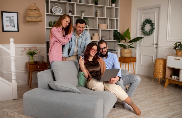 Full shot couple announcing pregnancy with laptop