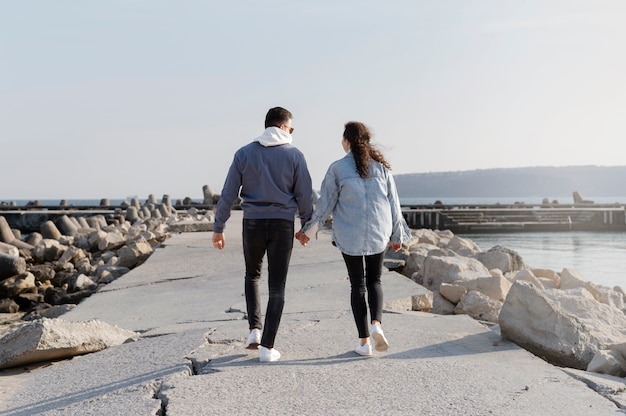 Full shot couple holding hands