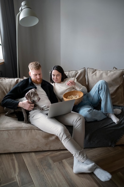 Photo full shot couple sitting on couch