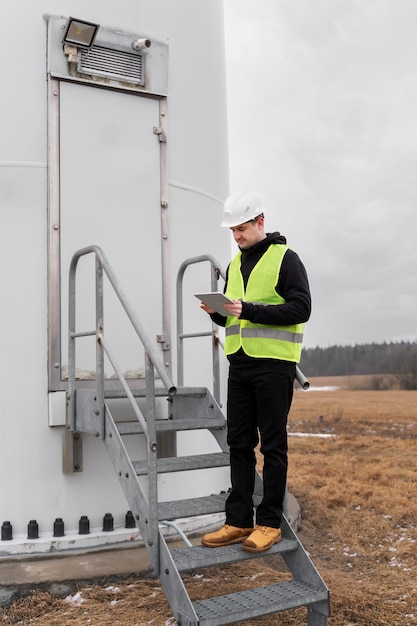 Full shot engineer standing on stairs