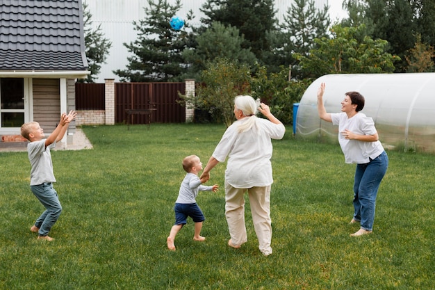 Full shot family playing outdoors