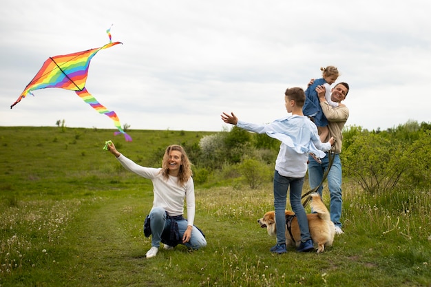 Famiglia a tutto campo che gioca con l'aquilone