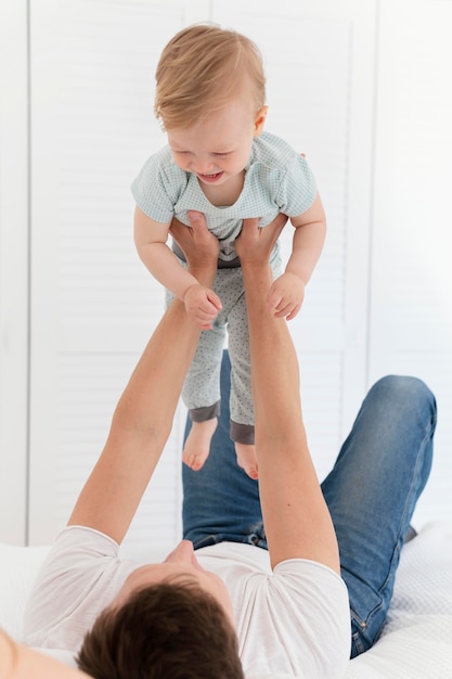 Full shot father holding kid