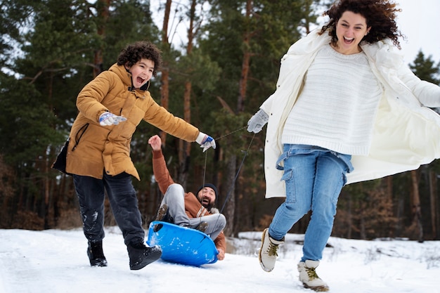 Full shot happy family playing outdoors