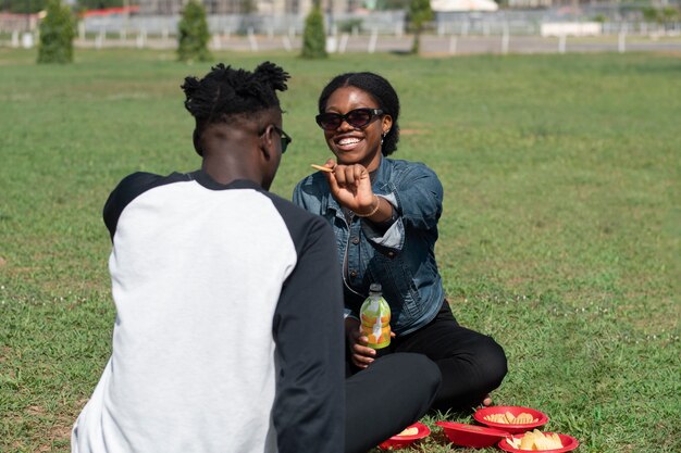 Photo full shot happy people sitting on grass