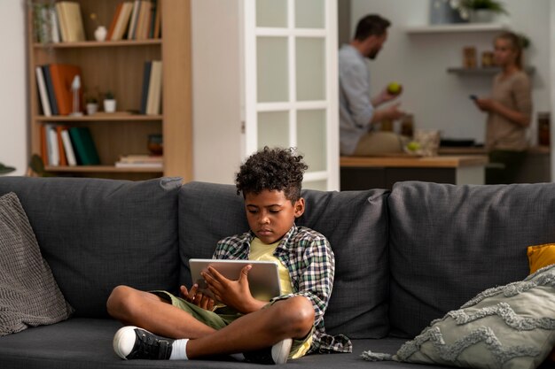 Full shot kid holding tablet