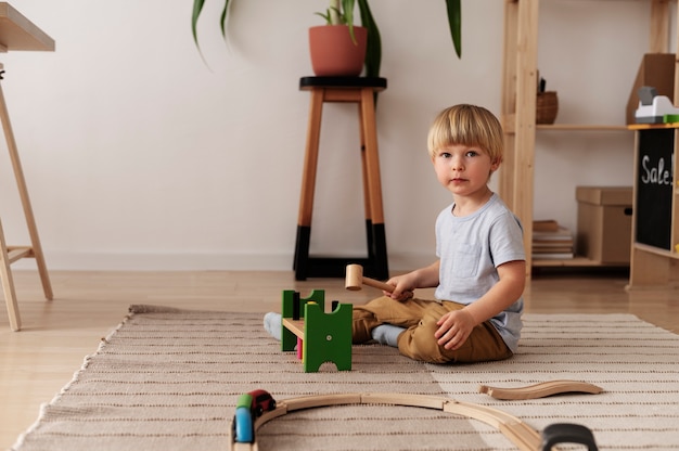 Full shot kid playing with toys at home