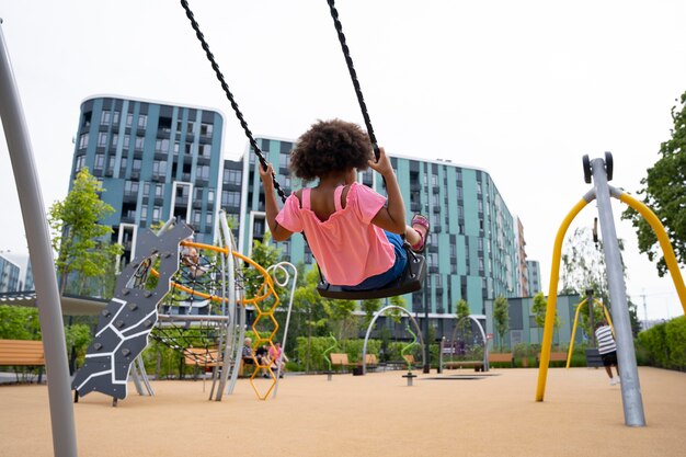 Full shot kid in swing