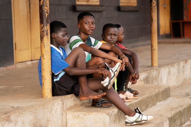 Full shot kids sitting on stairs outdoors