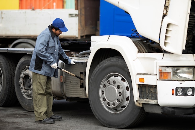 Full shot man checking truck