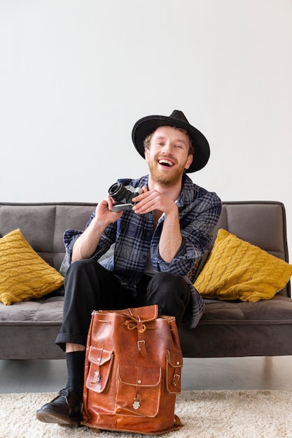 Full shot man holding camera