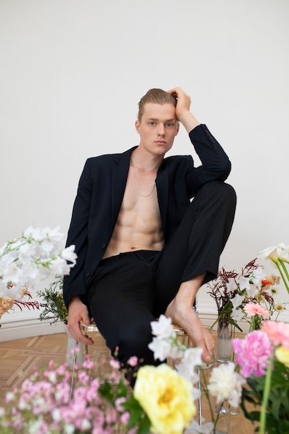 Full shot man posing with flowers