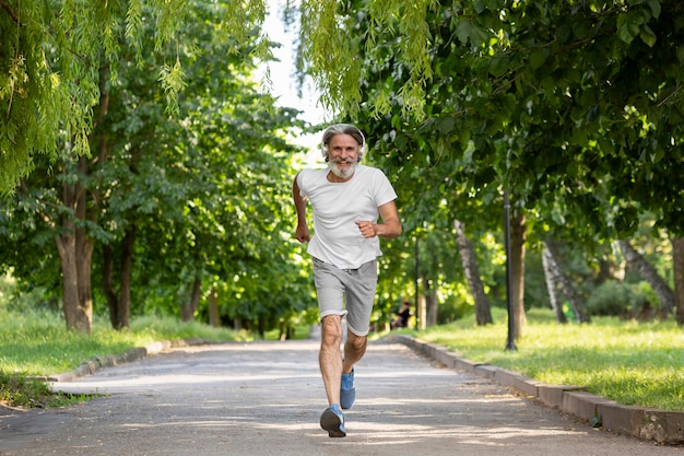 Full shot man running in park