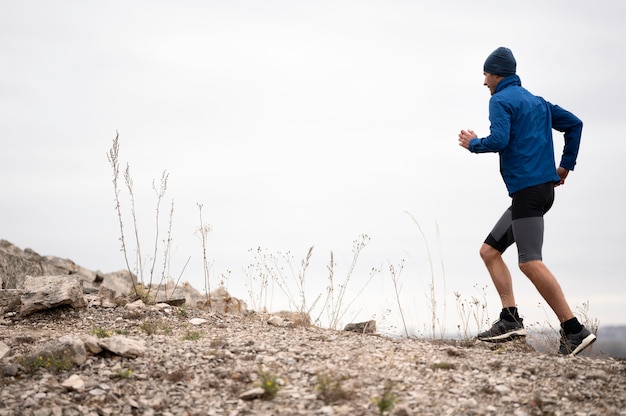 Full shot man running on trail