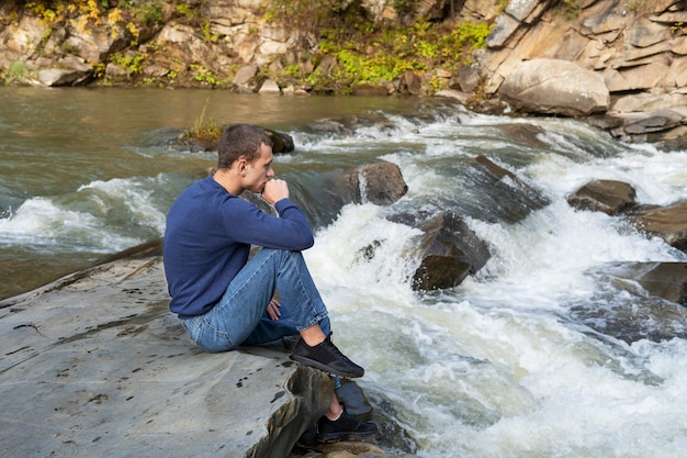 Full shot man sitting in nature