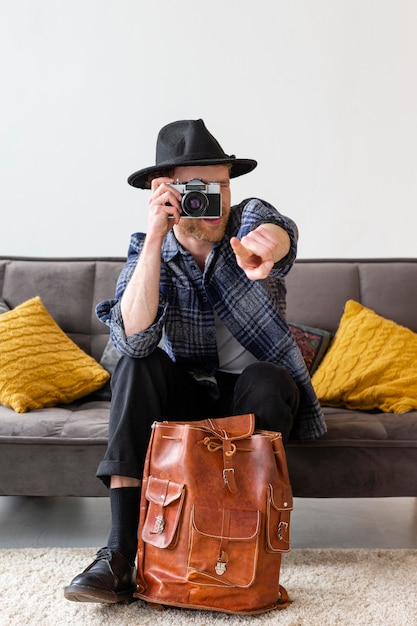 full shot man taking photos indoors