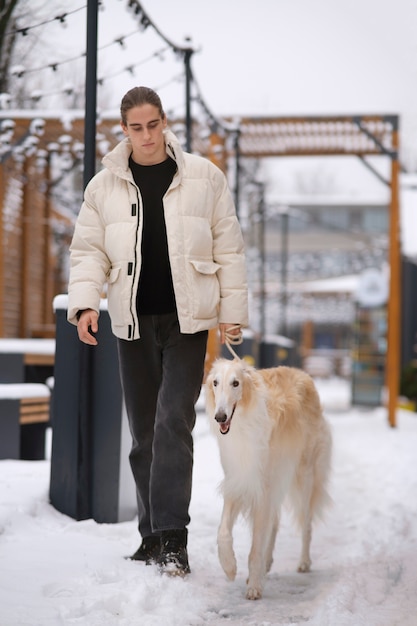 Photo full shot man with cute greyhound dog