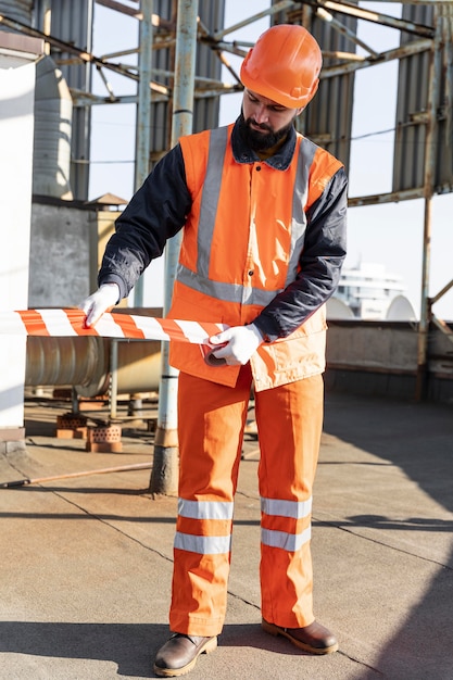 Full shot man working with helmet