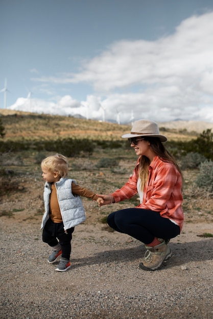 Full shot mother and boy in american desert